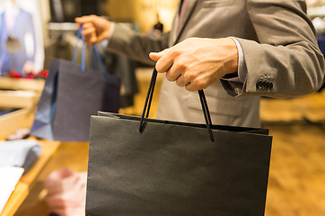 Image showing close up of man with shopping bags at store