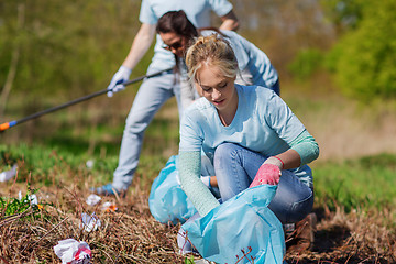 Image showing volunteers with garbage bags cleaning park area