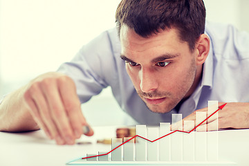 Image showing businessman with coins at office