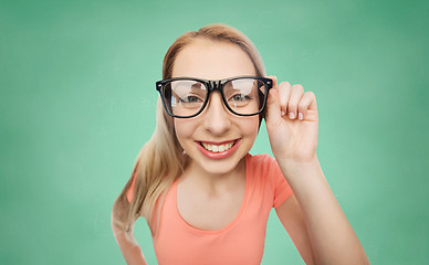 Image showing happy young woman or teenage girl in eyeglasses