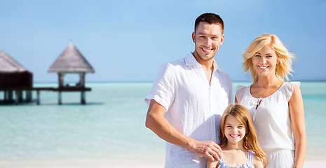 Image showing happy family over tropical beach with bungalow