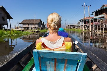 Image showing Female tourist travels by traditional boat.