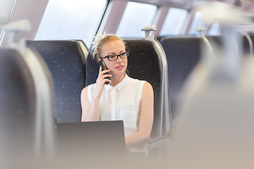 Image showing Business woman working while travelling by train.