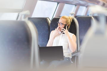 Image showing Business woman working while travelling by train.