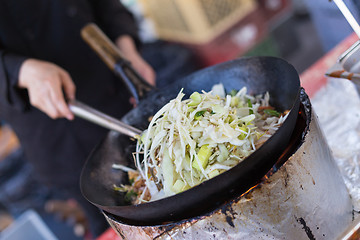 Image showing Cheff cooking on outdoor street food festival.