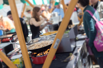 Image showing Cheff cooking on outdoor street food festival.