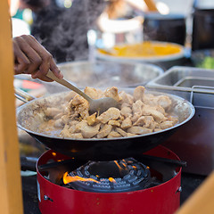 Image showing Cheff cooking on outdoor street food festival.