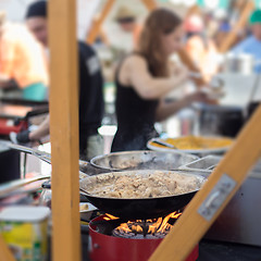 Image showing Cheff cooking on outdoor street food festival.