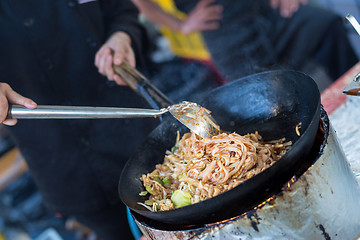 Image showing Cheff cooking on outdoor street food festival.