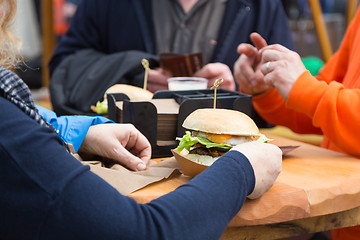 Image showing Beef burgers being served on street food stall