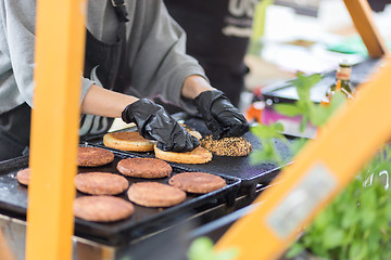 Image showing Beef burgers ready to serve on food stall.