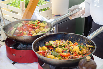 Image showing Cheff cooking on outdoor street food festival.