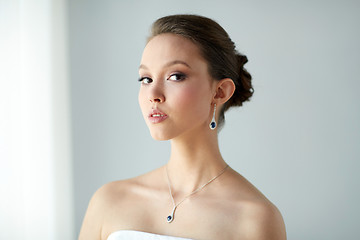 Image showing beautiful asian woman with earring and pendant