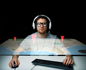 Image showing man in headset with computer keyboard and gps map