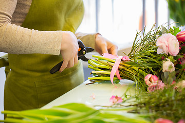 Image showing close up of florist woman with flowers and pruner