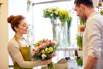 Image showing smiling florist woman and man at flower shop