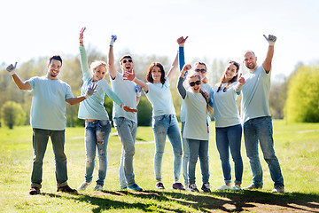 Image showing group of volunteers showing thumbs up in park