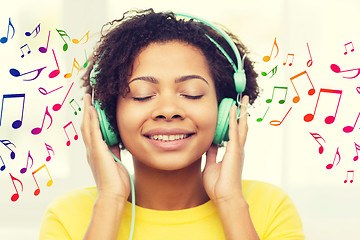 Image showing happy woman with headphones listening to music