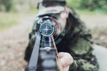 Image showing close up of soldier or sniper with gun in forest