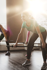 Image showing group of people exercising with bars in gym