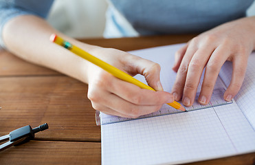 Image showing close up of hands with ruler and pencil drawing 