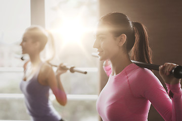 Image showing group of people exercising with bars in gym