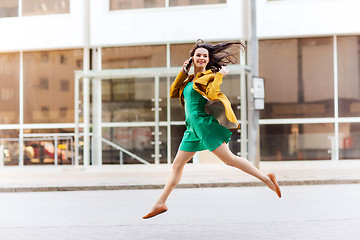 Image showing smiling young woman or girl calling on smartphone