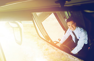 Image showing close up of driver reflection in bus mirror