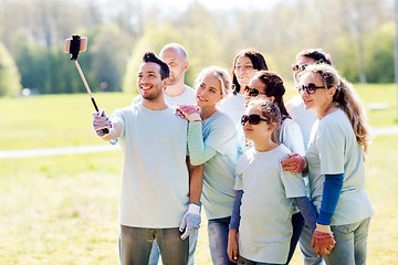 Image showing group of volunteers taking smartphone selfie