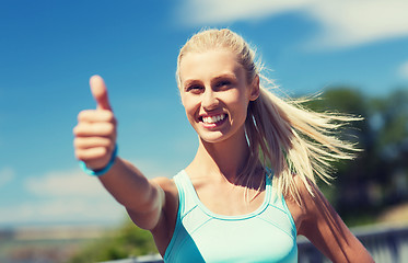 Image showing happy young woman exercising outside