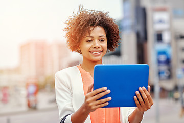 Image showing happy african businesswoman with tablet pc in city