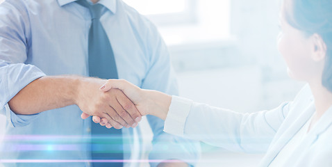 Image showing business people shaking hands in office