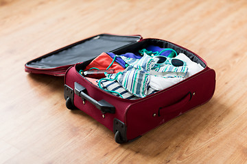 Image showing close up of travel bag with beach clothes