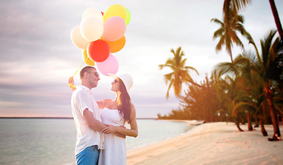 Image showing smiling couple with air balloons outdoors