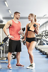 Image showing smiling man and woman talking in gym