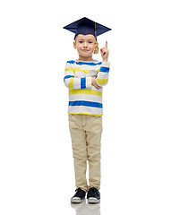 Image showing happy boy in bachelor hat pointing finger up