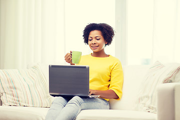 Image showing happy african american woman with laptop at home