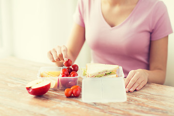 Image showing close up of woman with food in plastic container