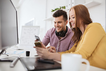 Image showing happy creative team with smartphones at office