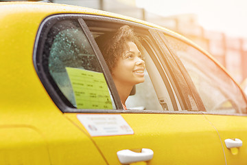 Image showing happy african american woman driving in taxi