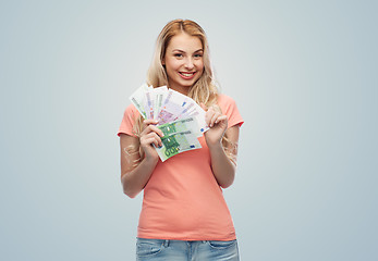 Image showing happy young woman with euro cash money