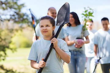 Image showing group of volunteers with trees and rake in park