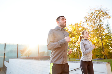 Image showing happy couple running upstairs on city stairs