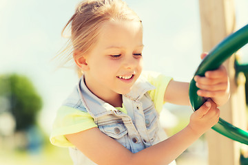 Image showing happy little girl climbing on children playground