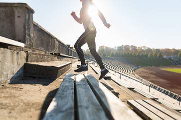 Image showing close up of woman running upstairs on stadium