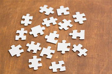 Image showing close up of puzzle pieces on wooden surface