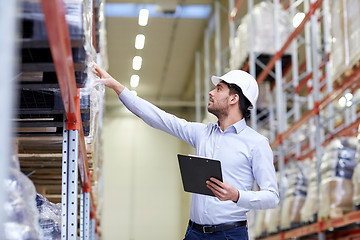 Image showing happy businessman with clipboard at warehouse