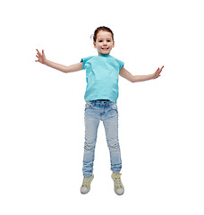 Image showing happy little girl jumping in air