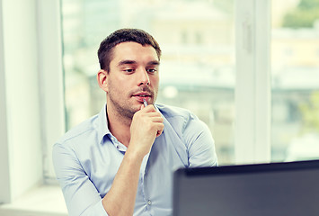 Image showing young businessman with laptop computer at office