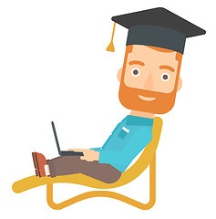 Image showing Graduate lying on chaise lounge with laptop.